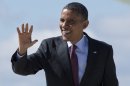 President Barack Obama waves as he arrives at General Mitchell International Airport on Air Force One, Saturday, Sept. 22, 2012, in Milwaukee. (AP Photo/Carolyn Kaster)