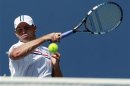 Roddick of the U.S. hits a return to compatriot Williams during their men's singles match at the U.S. Open tennis tournament in New York