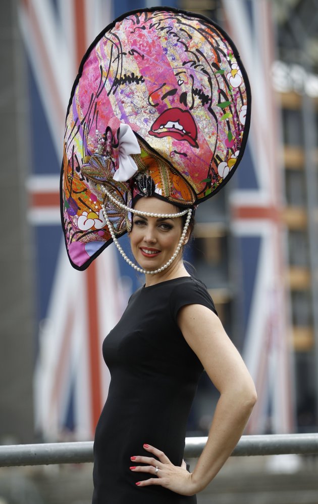 Racegoer Carla Greegan poses wearing a hat made from a painting at Royal Ascot on Ladies&#39; Day, southwest of London