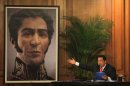 Venezuela's President Hugo Chavez unveils a photograph-like portrait of Venezuela's independence hero Simon Bolivar on the 229th anniversary of Bolivar's birth at Miraflores presidential palace in Caracas, Venezuela, Tuesday, July 24, 2012. A team of researchers produced the image based on studies of Bolivar's remains. (AP Photo/Fernando Llano)