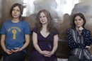 FILE In this Wednesday, Aug. 8, 2012 file photo feminist punk group Pussy Riot members, from left, Nadezhda Tolokonnikova, Maria Alekhina and Yekaterina Samutsevich sit in a glass cage at a court room in Moscow, Russia. Three members of Pussy Riot were jailed in March and charged with hooliganism motivated by religious hatred after their punk performance against President Putin in Moscow's main cathedral. Theyare awaiting the verdict on Friday, Aug. 17, 2012. (AP Photo/Misha Japaridze, file)