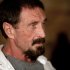 FILE - In this Dec. 4, 2012, file photo, software company founder John McAfee listens to a question during an interview at a local restaurant in Guatemala City.  McAfee said Sunday, Dec. 9, 2012, a live-stream Internet broadcast from the Guatemalan detention center where he is fighting a government order that he be returned to Belize, that he wants to return to the United States and "settle down to whatever normal life" he can. Police in neighboring Belize want to question McAfee in the fatal shooting of a U.S. expatriate who lived near his home on a Belizean island in November. (AP Photo/Moises Castillo, File)