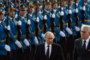 Serbian President Tomislav Nikolic, right, and Russian President Vladimir Putin review honor guard during a welcome ceremony in Belgrade, Serbia, Thursday, Oct. 16, 2014. Putin arrived in Serbia on Thursday for talks that are expected to focus on economic issues and energy, including construction of the South Stream gas pipeline that has been opposed by the European Union. (AP Photo/Vasily Maximov, Pool)