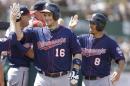 Minnesota Twins' Josh Willingham (16) is congratulated after hitting a two-run home run off Oakland Athletics' Luke Gregerson in the eighth inning of a baseball game Sunday, Aug. 10, 2014, in Oakland, Calif. (AP Photo/Ben Margot)