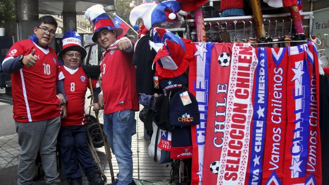 Fans of Chile await the start of the first round Copa America 2015 soccer match between Chile and Mexico on a street in Santiago