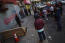 People gather near an installation by British graffiti artist Banksy in the Bronx section of New York