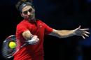 Switzerland's Roger Federer plays a return to Japan's Kei Nishikori during their singles ATP World Tour tennis finals match at the O2 arena in London, Tuesday, Nov. 11, 2014. (AP Photo/Alastair Grant)