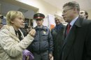Opposition activist Yevgenia Chirikova, left, speaks to Khimki acting mayor Oleg Shakhov at a polling station in the town of Khimki, outside Moscow, Russia, Sunday, Oct. 14, 2012. Chirikova who played a major role in the massive winter protests against Putin's rule, is challenging the incumbent mayor. She has complained of an uneven playing field, saying authorities tried to thwart her meetings with voters and put up other obstacles. (AP Photo/Mikhail Metzel)