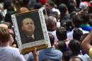 A supporter of late Brazilian presidential candidate Eduardo Campos holds a portrait of him in Recife, Brazil on August 17, 2014
