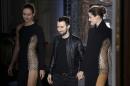 Belgian fashion designer Anthony Vaccarello (C) acknowledges the public at the end of his Fall/Winter 2013-2014 ready-to-wear collection show on February 26, 2013 in Paris