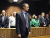 Olympian Oscar Pistorius stands following his bail hearing in Pretoria, South Africa, Tuesday, Feb. 19, 2013. Pistorius fired into the door of a small bathroom where his girlfriend was cowering after a shouting match on Valentine's Day, hitting her three times, a South African prosecutor said Tuesday as he charged the sports icon with premeditated murder. The magistrate ruled that Pistorius faces the harshest bail requirements available in South African law. He did not elaborate before a break was called in the session. (AP Photo)
