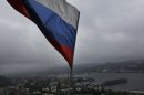 A Russian flag flies above the port in the eastern Russian city of Vladivostok Wednesday, Sept. 5, 2012. Once a mysterious closed city during Soviet times, Vladivostok is ready to strut in the world spotlight as host of the Asia-Pacific Economic Cooperation summit. Russia has splashed $20 billion preparing for the summit in Vladivostok, its largest but long-neglected Pacific port, as part of a grand plan to become a bigger player on Asian markets. (AP Photo/Vincent Yu)