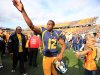 West Virginia quarterback Geno Smith gestures to fans after their NCAA college football game against Baylor in Morgantown, W.Va., Saturday, Sept. 29, 2012. Smith threw for 656 yards and tied a Big 12 record with eight touchdown passes to lead No. 9 West Virginia to a 70-63 win over No. 25 Baylor . (AP Photo/Christopher Jackson)