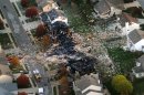This aerial photo shows the two homes that were leveled and the numerous neighboring homes that were damaged from a massive explosion that sparked a huge fire and killed two people, Sunday, Nov. 11, 2012, in Indianapolis. Nearly three dozen homes were damaged or destroyed, and seven people were taken to a hospital with injuries authorities said Sunday. The powerful nighttime blast shattered windows, crumpled walls and could be felt at least three miles away. (AP Photo/The Indianapolis Star, Matt Kryger) NO SALES