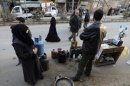 A man selling petrol and gas waits for clients in Ain Tarma neighbourhood, Damascus