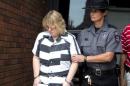 Joyce Mitchell is escorted out of the court house after pleading guilty at Clinton County Court, in Plattsburgh, New York