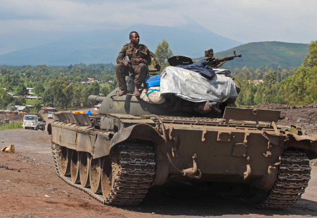 A Congolese army tank overlooking Munigi and the road to Rutshuru where fighting between the M23 and the Congolese army has been taking place in the past days near Goma, Congo, Monday, Nov. 19, 2012. Rebels believed to be backed by Rwanda fired mortars and machine guns Monday in a village on the outskirts of the provincial capital of Goma and threatened to attack the city which is protected by ragtag Congolese government troops backed by United Nations peacekeepers. The gunfire and explosions erupted in the early afternoon, hours after the M23 rebels said they were halting fighting in order to negotiate with the government of Congo. (AP Photo/Melanie Gouby)