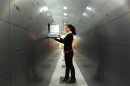 A woman takes a deposit box out of a compartment in the safe room of an Austrian bank in Vienna