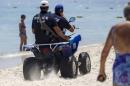 Police officers patrol the beach near the Imperial Marhabada resort, which was attacked by a gunman in Sousse