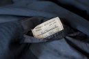A tailor's tag with the name "Paul Newman" is seen on a suit found by Peter Gamlen in the basement of his apartment in New Haven, Conn., Tuesday, Oct. 9, 2012. Gamlen believes the suit belonged to the actor. (AP Photo/Jessica Hill)