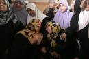 Palestinian relatives mourn during the funeral of Mahmud Homaida in Gaza City, on October 17, 2015