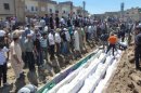 The victims of the Houla massacre are buried in a mass grave after the massacre that sparked new fury against Assad