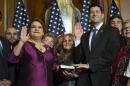 House Speaker Paul Ryan of Wis. administers the House oath of office to Puerto Rico Resident Commissioner Jenniffer Gonzalez during a mock swearing in ceremony on Capitol Hill in Washington, Tuesday, Jan. 3, 2017. (AP Photo/Zach Gibson)