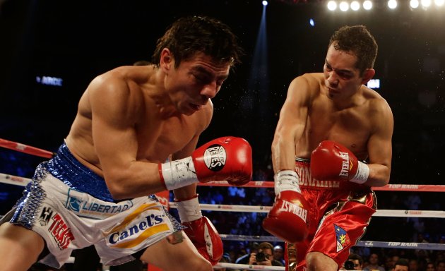 HOUSTON, TX - DECEMBER 15:  Nonito Donaire of the Philippines (R) hits Jorge Arce of Mexico in their WBO World Super Bantamweight bout at the Toyota Center on December 15, 2012 in Houston, Texas.  (Photo by Scott Halleran/Getty Images)