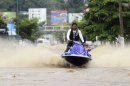 A man rides a jet ski in a flooded street in Acapulco on September 16, 2013
