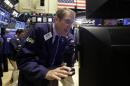 Trader Luke Scanlon works on the floor of the New York Stock Exchange Thursday, Oct. 16, 2014. U.S. stocks are opening lower while European markets suffer even steeper declines. (AP Photo/Richard Drew)