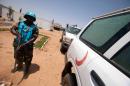 A handout picture released by the United Nations-African Union Mission in Darfur (UNAMID) on July 14, 2013 shows a UNAMID peacekeeper from Tanzania and based in Khor Abeche in South Darfur standing next to an ambulance