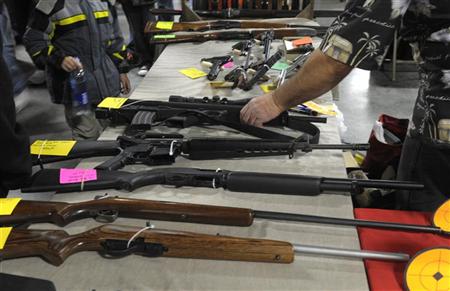 A dealer displays firearms for sale at a gun show in Kansas City, Missouri December 22, 2012. REUTERS/Dave Kaup
