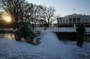 Workers plow snow from the sidewalk in front of the White House in Washington