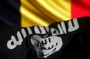 Islamic State flag is seen in front of a Belgian flag in this illustration