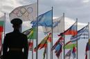A Russian soldier stands in front of the flags during the welcoming ceremony for the U.S Olympic team in the Athletes Village at the Olympic Park ahead of the 2014 Winter Olympic Games in Sochi