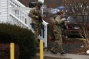 Members of a Connecticut State Police SWAT team walk from a building on the grounds of the St. Rose of Lima Catholic church in Newtown, Connecticut
