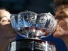Jarmila Gajdosova and Matthew Ebden of Australia kiss the trophy after defeating Lucie Hradecka and Frantisek Cermak of Czech Republic in their mixed doubles final match at the Australian Open tennis tournament in Melbourne