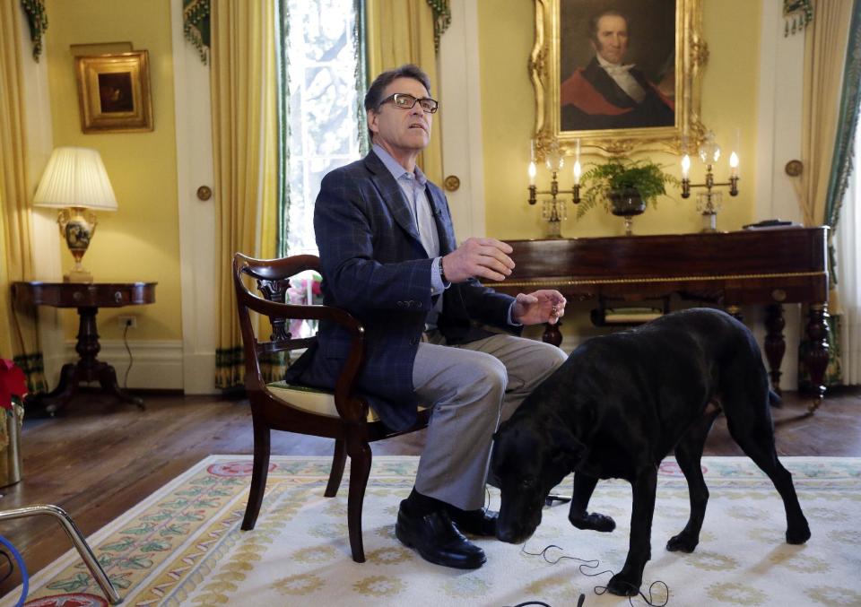 In this photo taken Dec. 9, 2014, Texas Gov. Rick Perry answers questions during an interview at the historic Texas Governor's Mansion in Austin, ...