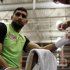 Boxing champion Khan of Britain has his hand taped by trainer Roach before working out in Washington
