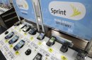 In this Tuesday, July 17, 2012, photo, sprint phones are displayed at a Best Buy in Mountain View, Calif. Sprint Nextel reported Thursday July 26, 2012, losses widened in the second quarter as the country's third-largest wireless carrier wrote down the value of its moribund Nextel network. (AP Photo/Paul Sakuma)
