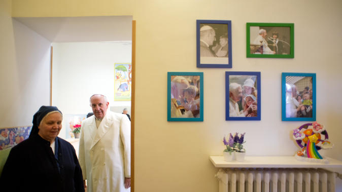 In this photo provided by the Vatican newspaper L&#39;Osservatore Romano Pope Francis visits the Santa Marta dispensary at the Vatican, Saturday, Dec. 14, 2013. For more than 90 years, the dispensary on the Vatican grounds has been distributing milk, clothing, diapers, toys and even baby carriages to families in need. (AP Photo/L&#39; Osservatore Romano, HO)