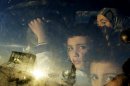 Syrian children look through their car window as they cross into Lebanon with their families at the border crossing, in Masnaa, eastern Lebanon, Friday, Nov. 30, 2012. (AP Photo/Hassan Ammar)
