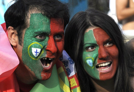 Portugal fans cheer before the semifinal match between Spain and Portugal at the Euro 2012 soccer championship in Donetsk, Ukraine, Wednesday, June 27, 2012. (AP Photo/Sergei Chuzavkov)