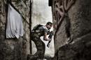 This photo of a Free Syrian Army fighter taking up a position during clashes against government forces in the Sulemain Halabi district of Aleppo on October 10, 2012 is part of Fabio Bucciarelli's award winning series 'Battle to Death'