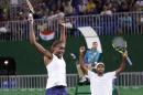 Venus Williams, left, and her partner Rajeev Ram, of the United States, celebrate after defeating India during their semi-final mixed doubles match at the 2016 Summer Olympics in Rio de Janeiro, Brazil, Saturday, Aug. 13, 2016. The United States advances to the gold medal game. (AP Photo/Charles Krupa)