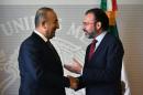 Turkish Foreign Minister Mevlut Cavusoglu (L), shakes hands with Mexican Foreign Minister Luis Videgaray, during a press conference at the Foreign Ministry building in Mexico City on February 3, 2017