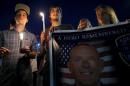 Mourners attend a candlelight vigil for slain Fox Lake Police Lieutenant Charles Joseph Gliniewicz in Fox Lake