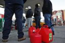Customers wait in line for gas at a Hess fuelling station in Brooklyn, New York