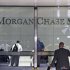 People are seen in the lobby of JP Morgan Chase's international headquarters on Park Avenue in New York
