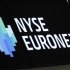 A NYSE Euronext sign is seen over the the floor of the New York Stock Exchange